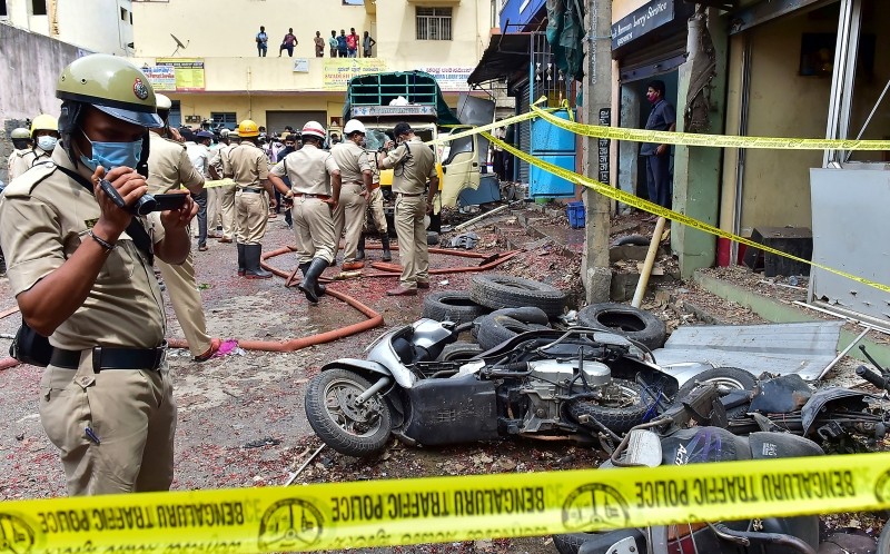 Bengaluru: Police personnel inspect the blast site at New Tharagupet area in Benagaluru,  Thursday, Sept.23, 2021. (PTI Photo)